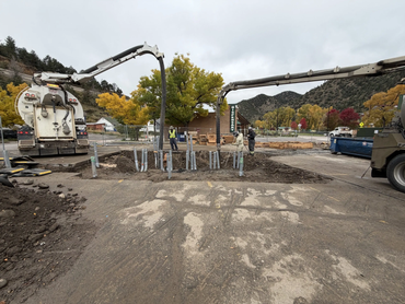  Vacuum excavation trucks exposing underground utility lines at a commercial development site 