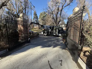  Biolein TruVac vacuum truck positioned at a wrought iron entrance gate for hydro excavation service 