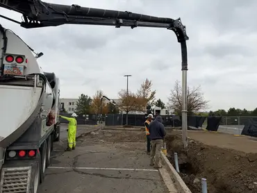  Biolein crew performing hydro excavation around utility conduit in a commercial parking lot 